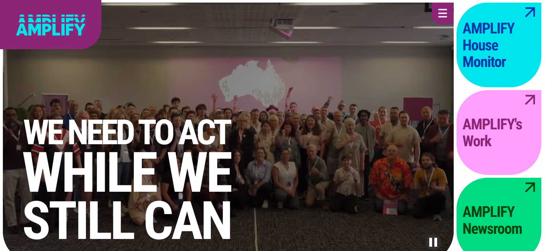 Large group posing indoors with text: We need to act while we still can.